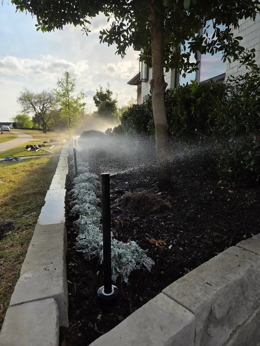 Drip irrigation heads in colorful garden bed